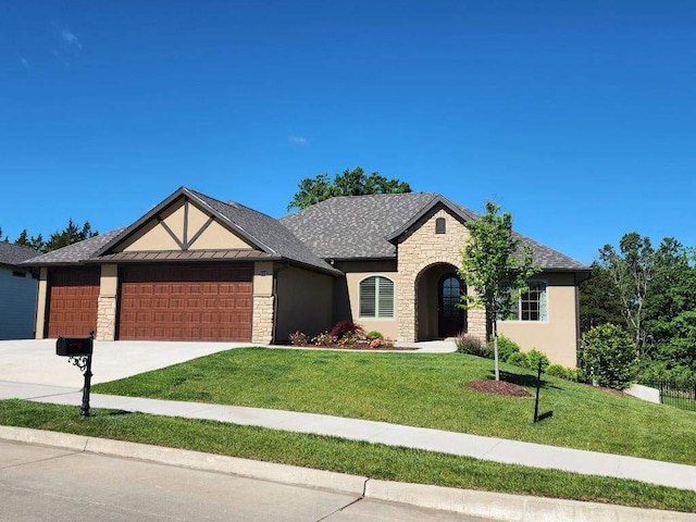 5005 Kiawah Ln, Columbia, MO 65203 - view of front of house with stone siding, an attached garage, a front yard, driveway, and stucco siding