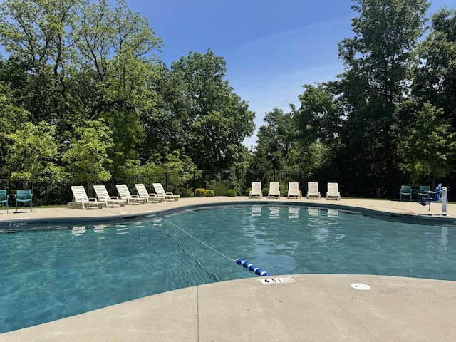 5005 Kiawah Ln, Columbia, MO 65203 - community pool featuring a patio area and view of wooded area