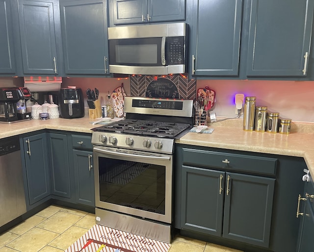 4011 Spring Cress Dr, Columbia, MO 65202 - kitchen featuring stainless steel appliances, light countertops, and light tile patterned floors
