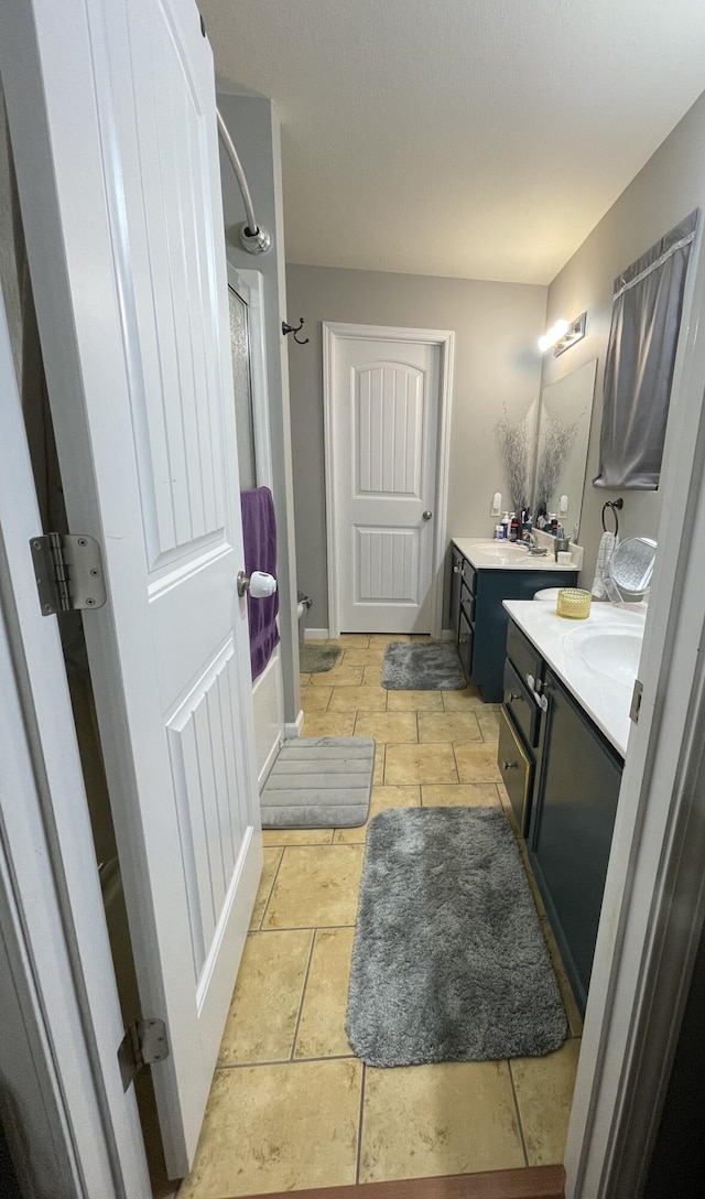 4011 Spring Cress Dr, Columbia, MO 65202 - bathroom with two vanities, a shower, and baseboards