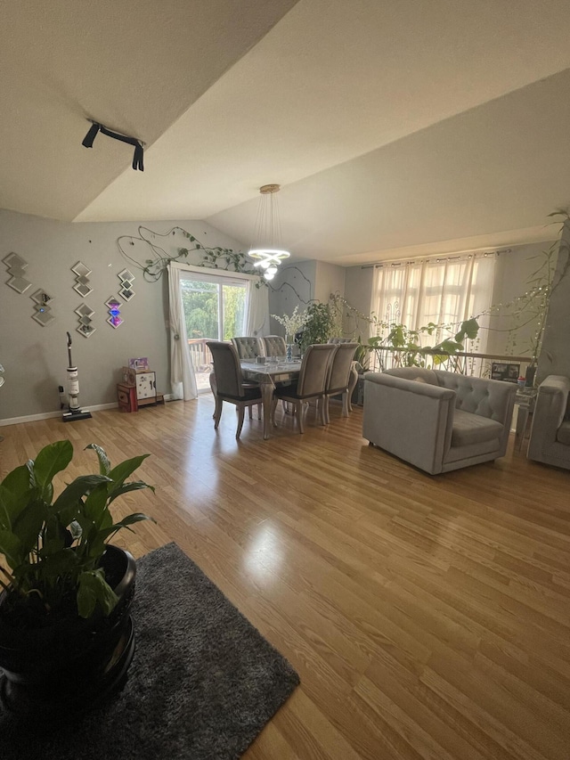 4011 Spring Cress Dr, Columbia, MO 65202 - dining space with wood finished floors, a chandelier, and vaulted ceiling