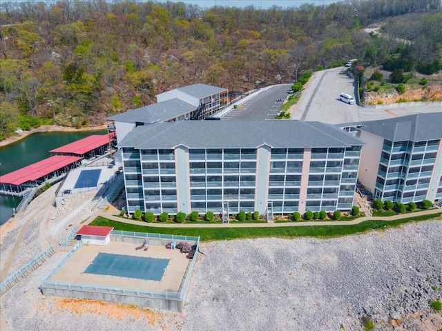 bird's eye view featuring a wooded view and a water view