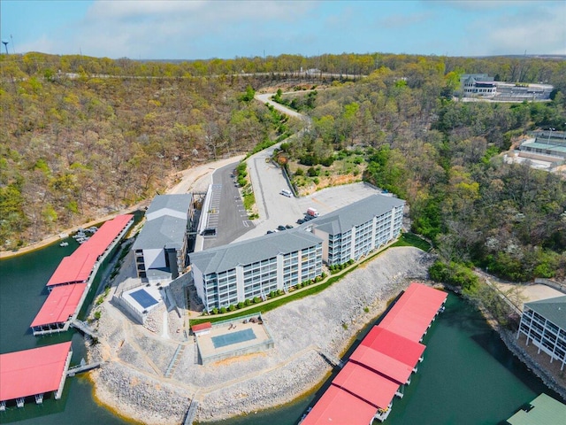 drone / aerial view featuring a water view and a wooded view