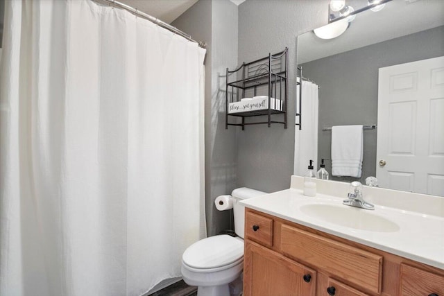 full bath featuring toilet and vanity