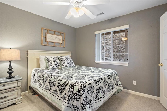 carpeted bedroom featuring ceiling fan, baseboards, and visible vents