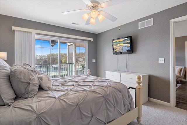 carpeted bedroom with baseboards, access to outside, visible vents, and a ceiling fan