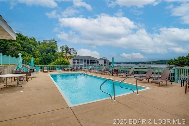 pool featuring fence and a patio