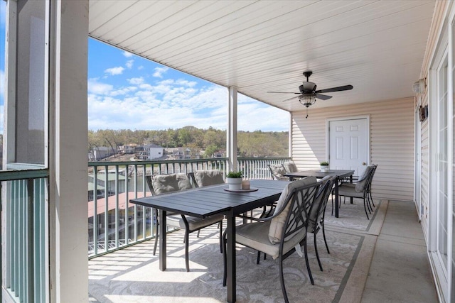 exterior space with a water view, outdoor dining area, and a ceiling fan