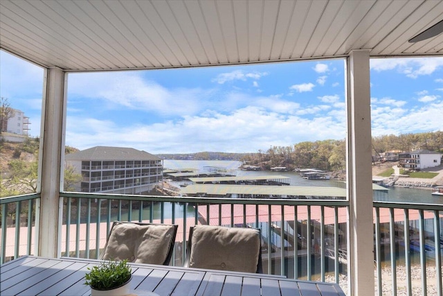 wooden terrace featuring a water view