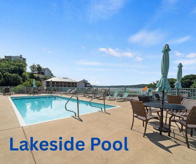 community pool featuring a patio area and fence