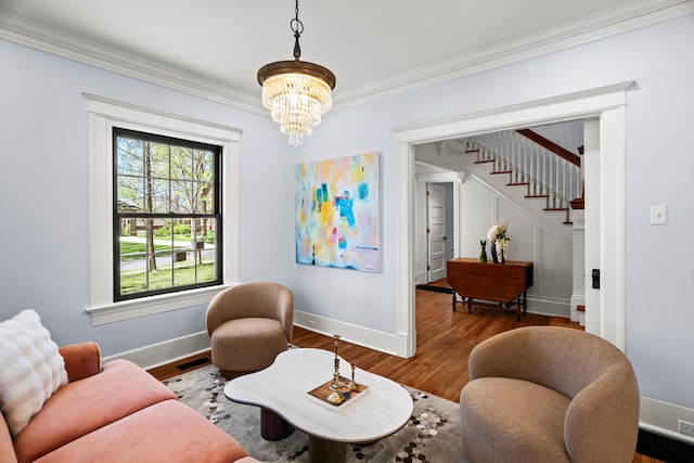 608 Westmount Ave, Columbia, MO 65203 - living area with baseboards, a chandelier, crown molding, stairs, and wood finished floors