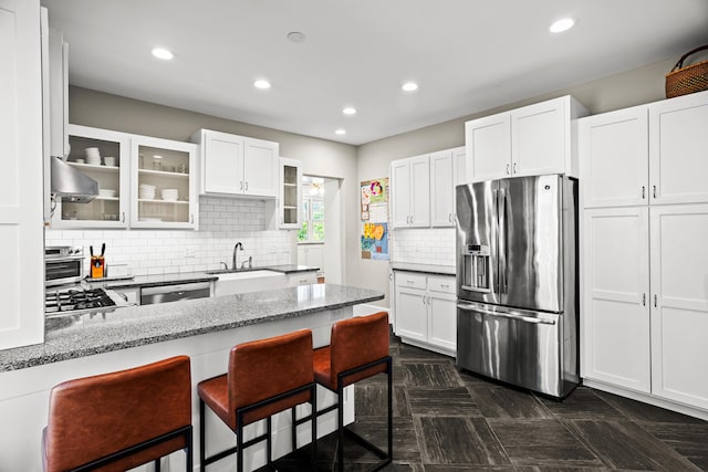 608 Westmount Ave, Columbia, MO 65203 - kitchen featuring appliances with stainless steel finishes, a sink, glass insert cabinets, light stone countertops, and recessed lighting