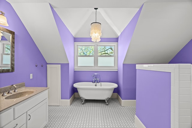 608 Westmount Ave, Columbia, MO 65203 - full bath featuring baseboards, vaulted ceiling, vanity, and a freestanding bath