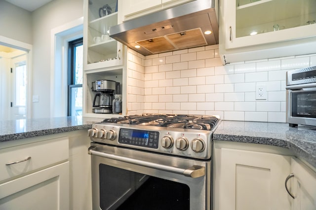 608 Westmount Ave, Columbia, MO 65203 - kitchen with stainless steel gas range, range hood, backsplash, and white cabinetry
