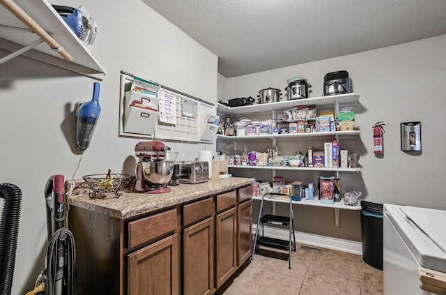 interior space featuring light tile patterned floors and baseboards