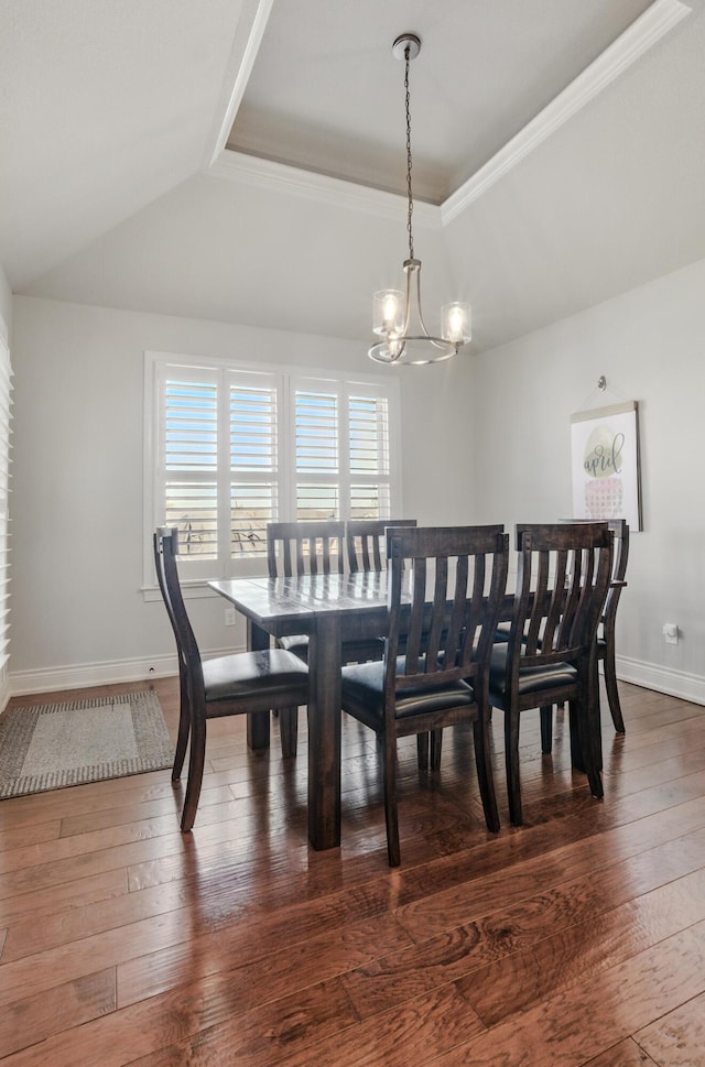 dining room with a tray ceiling, a notable chandelier, dark wood-style floors, and baseboards