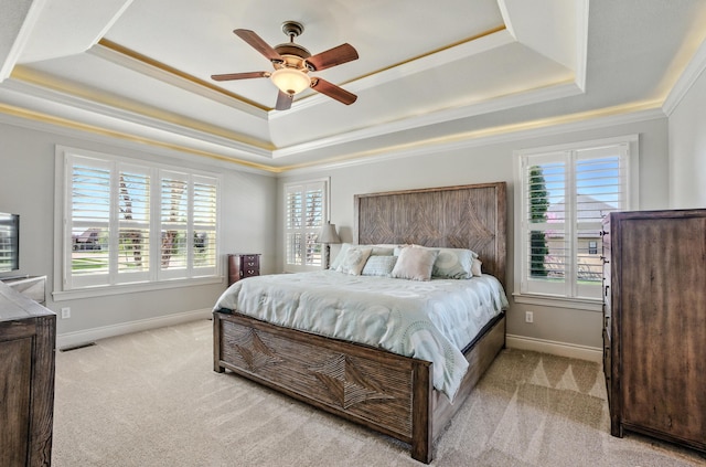 bedroom featuring baseboards, ornamental molding, light carpet, visible vents, and a raised ceiling