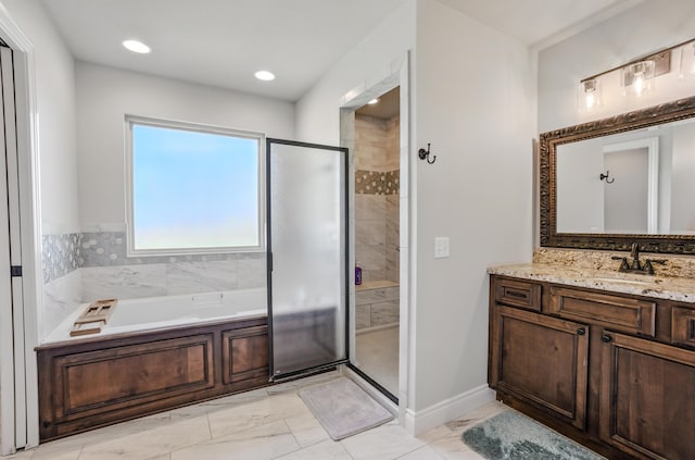 bathroom featuring marble finish floor, a garden tub, and a stall shower