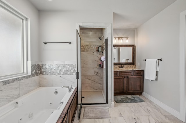 bathroom featuring marble finish floor, a stall shower, vanity, and a tub with jets