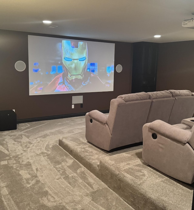 carpeted cinema room with baseboards