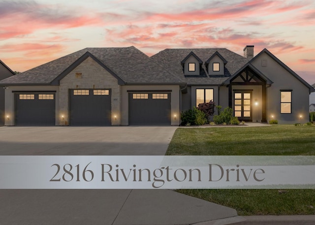 2816 Rivington Dr, Columbia, MO 65203 - view of front of property featuring a chimney, a garage, a front lawn, driveway, and a shingled roof