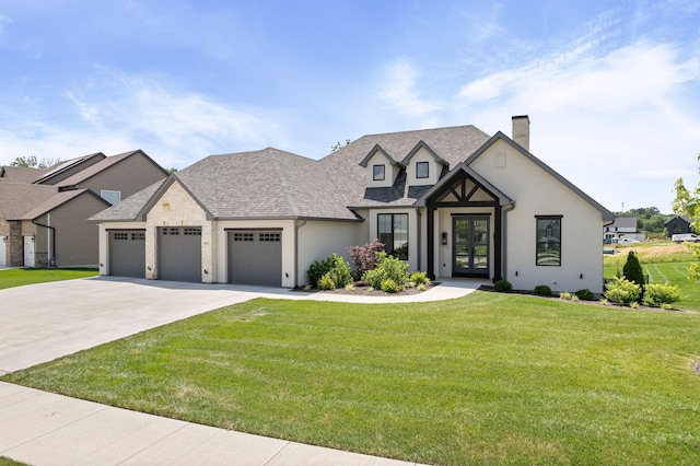 2816 Rivington Dr, Columbia, MO 65203 - view of front facade with french doors, a chimney, an attached garage, driveway, and a front yard