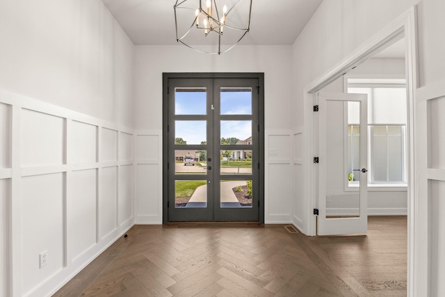 2816 Rivington Dr, Columbia, MO 65203 - foyer with a decorative wall, french doors, a chandelier, and wainscoting