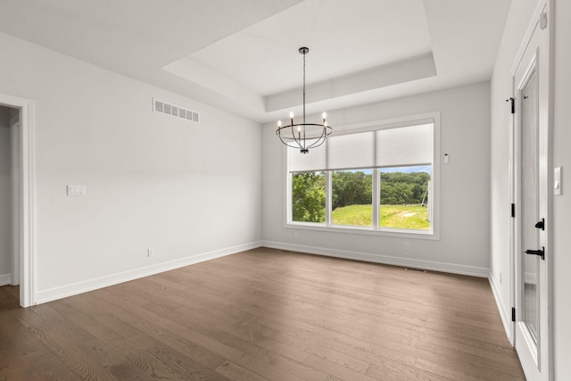 2816 Rivington Dr, Columbia, MO 65203 - spare room with a raised ceiling, dark wood finished floors, and a chandelier