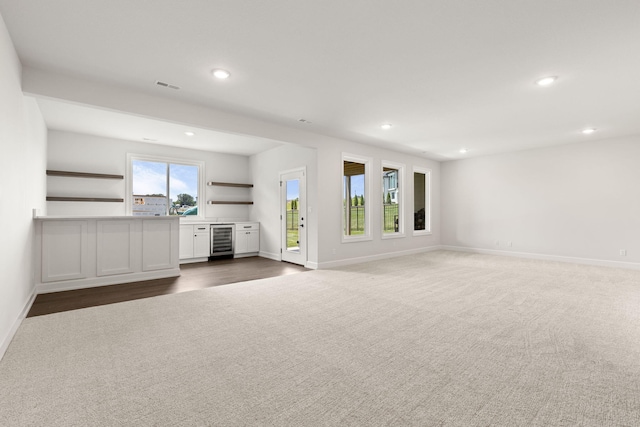 2816 Rivington Dr, Columbia, MO 65203 - unfurnished living room with wine cooler, recessed lighting, and dark carpet