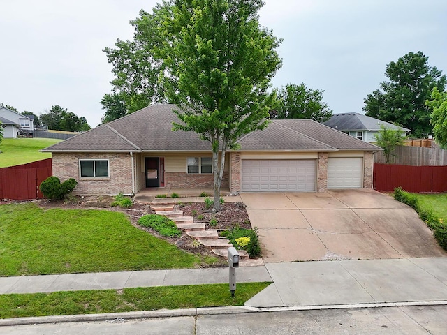 4204 Fourwinds Dr, Columbia, MO 65202 - view of front facade with an attached garage, brick siding, concrete driveway, and roof with shingles