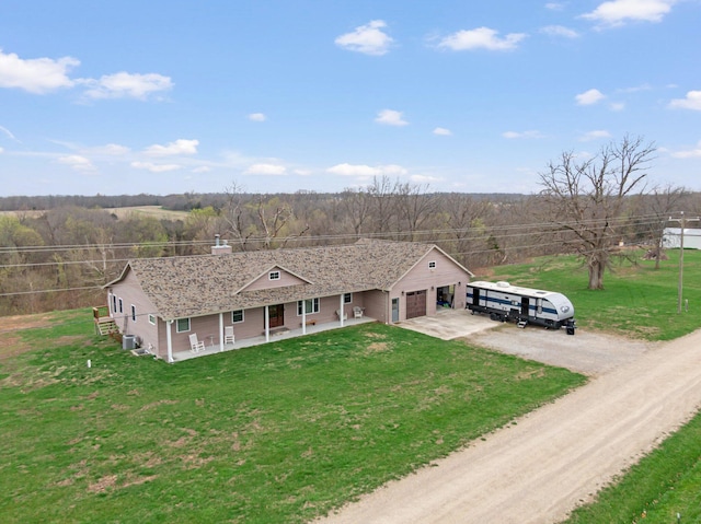 drone / aerial view with a view of trees