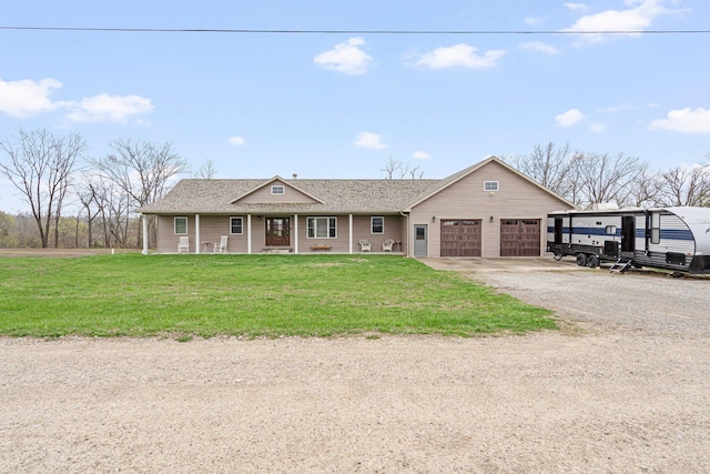 single story home with a front yard, a shingled roof, a garage, and driveway