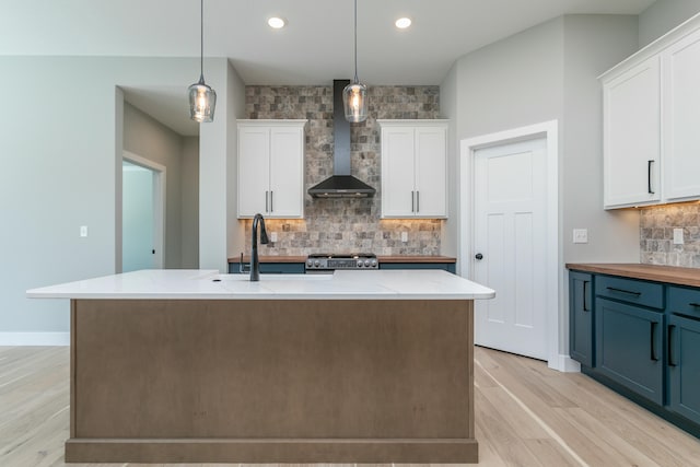 700 Brockton Dr, Columbia, MO 65201 - kitchen with wall chimney exhaust hood, stainless steel range oven, light wood-style floors, white cabinetry, and recessed lighting