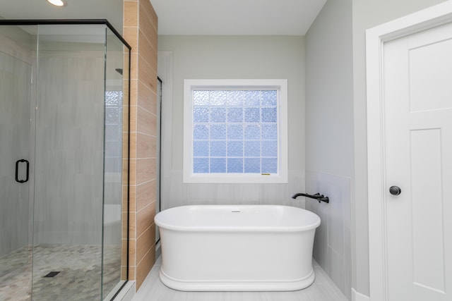 700 Brockton Dr, Columbia, MO 65201 - bathroom featuring a soaking tub, a shower stall, and tile walls