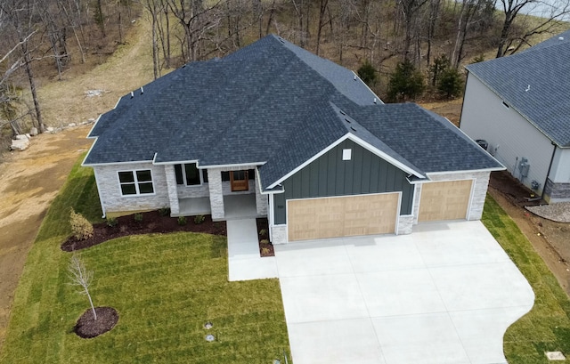700 Brockton Dr, Columbia, MO 65201 - view of front of property featuring a garage, board and batten siding, roof with shingles, driveway, and a front lawn