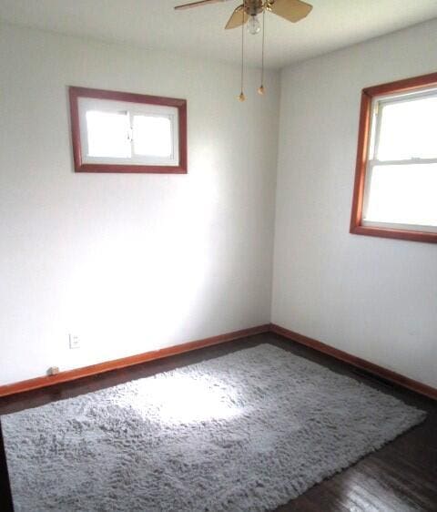 614 S Central St, Centralia, MO 65240 - empty room featuring wood finished floors, baseboards, and a ceiling fan