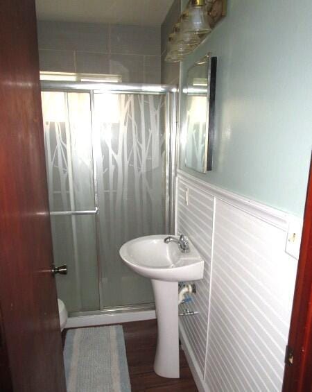 614 S Central St, Centralia, MO 65240 - bathroom with a stall shower and wainscoting
