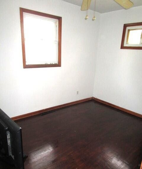 614 S Central St, Centralia, MO 65240 - empty room with a wealth of natural light, baseboards, and wood finished floors
