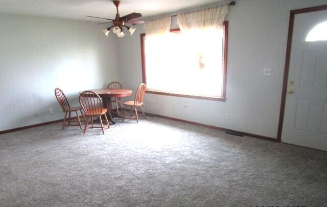 614 S Central St, Centralia, MO 65240 - dining room featuring ceiling fan, baseboards, and carpet floors