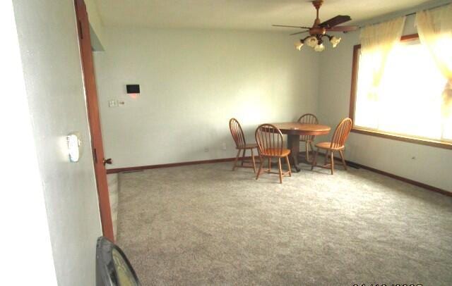 614 S Central St, Centralia, MO 65240 - dining area with carpet floors, baseboards, and a ceiling fan
