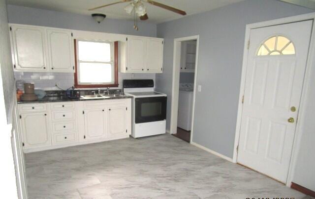 614 S Central St, Centralia, MO 65240 - kitchen featuring stove, a ceiling fan, white cabinets, a sink, and dark countertops