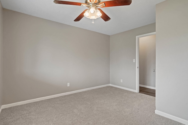 carpeted empty room with baseboards and ceiling fan