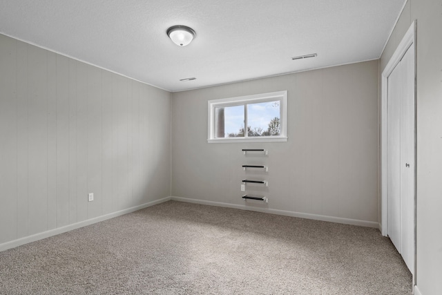unfurnished bedroom featuring visible vents, baseboards, carpet flooring, and a closet