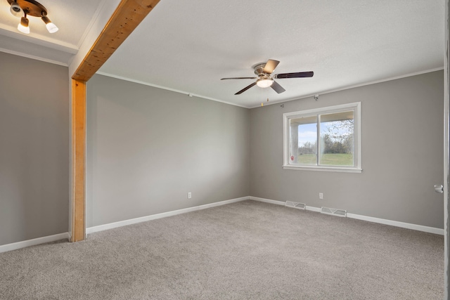 spare room featuring baseboards, visible vents, carpet floors, and ceiling fan