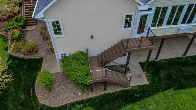 back of property featuring stairway, stucco siding, and a patio
