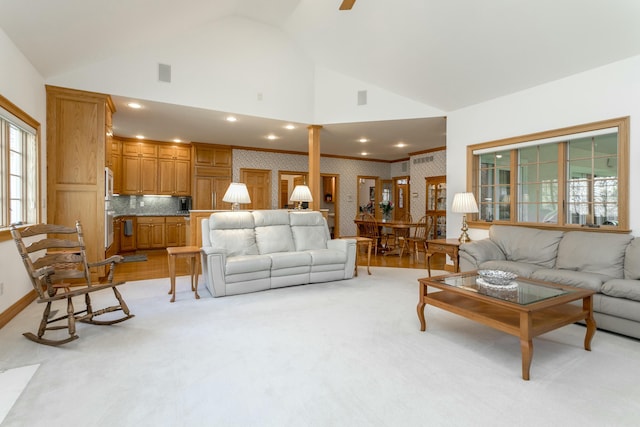 living room featuring light wood finished floors, a ceiling fan, high vaulted ceiling, wallpapered walls, and recessed lighting
