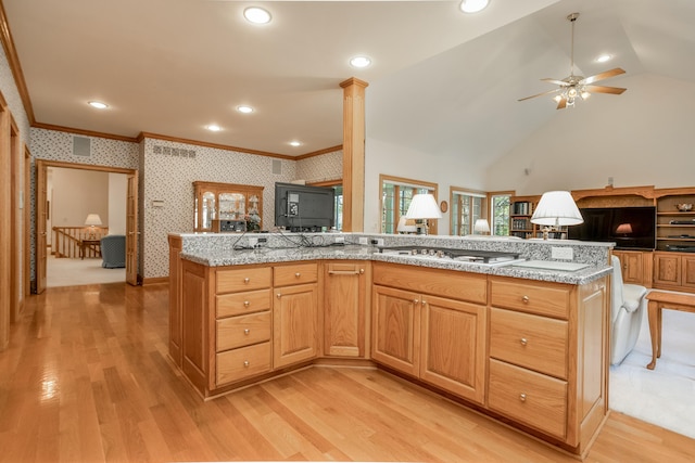 kitchen featuring a ceiling fan, wallpapered walls, stainless steel gas cooktop, crown molding, and light wood-type flooring