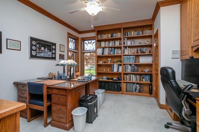 office space featuring ceiling fan, crown molding, and light colored carpet