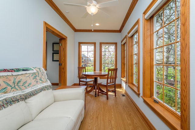 sunroom with french doors, wood finished floors, ornamental molding, recessed lighting, and baseboards