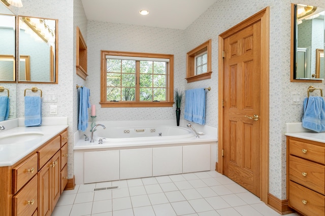 bathroom featuring a sink, a whirlpool tub, two vanities, and wallpapered walls